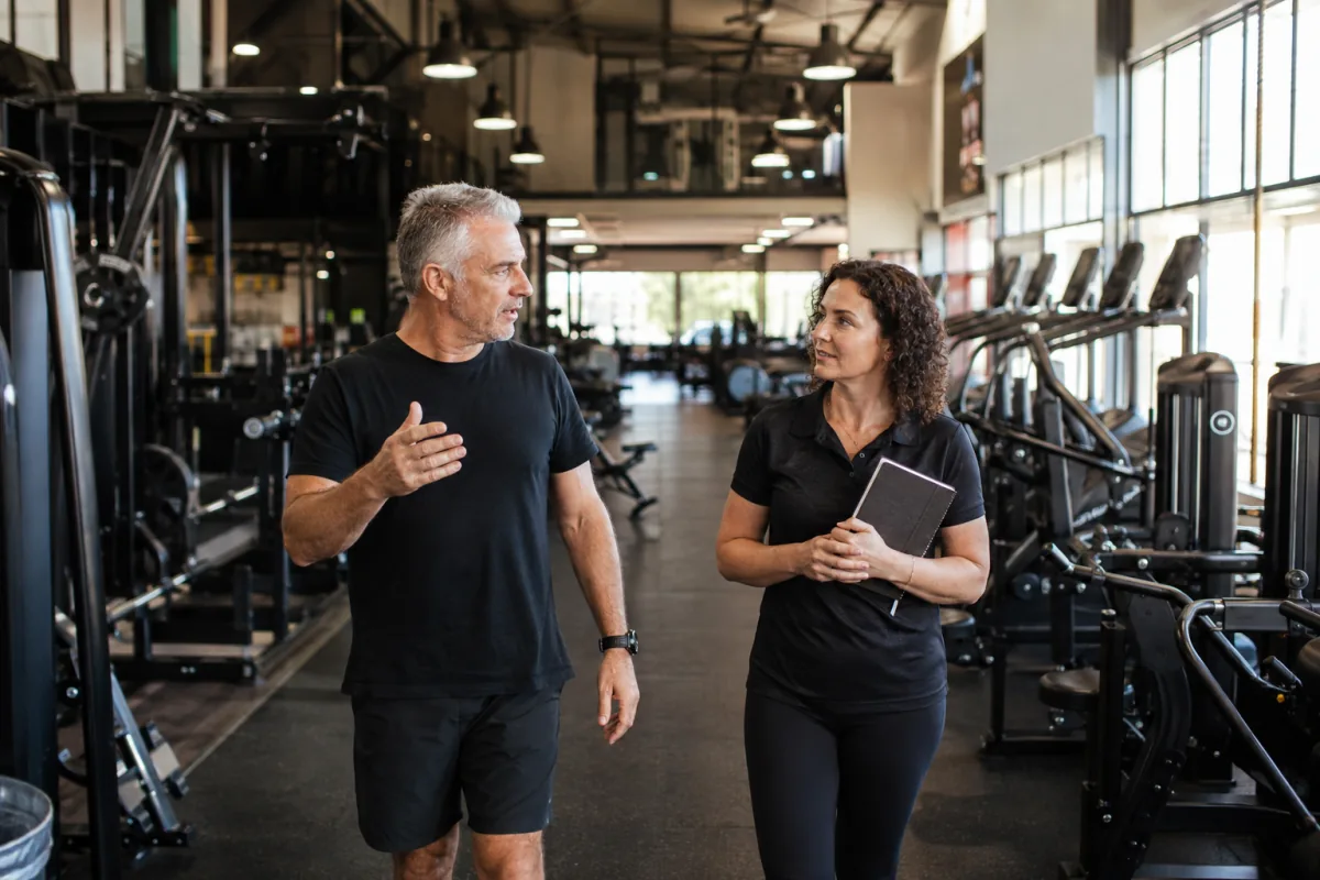Gym owner and operations manager reviewing their facility