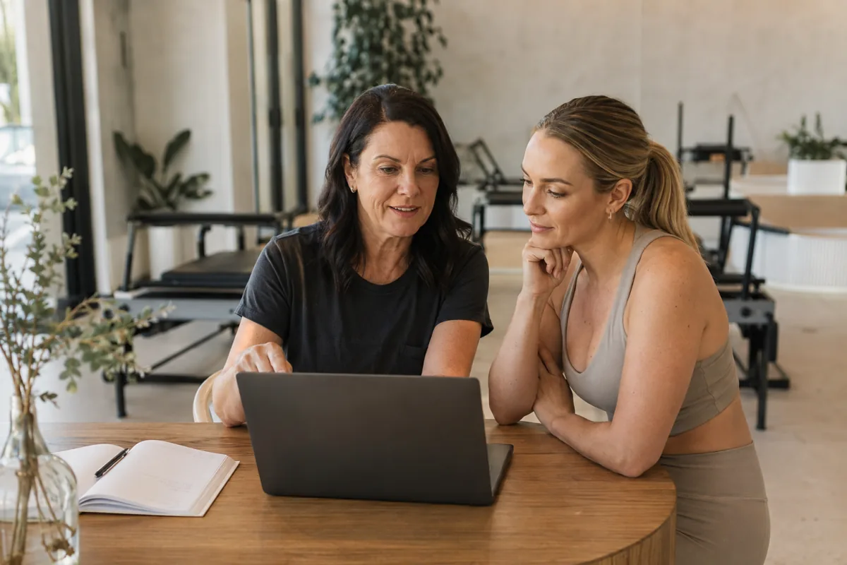Studio owner and colleague comparing software at a Pilates studio